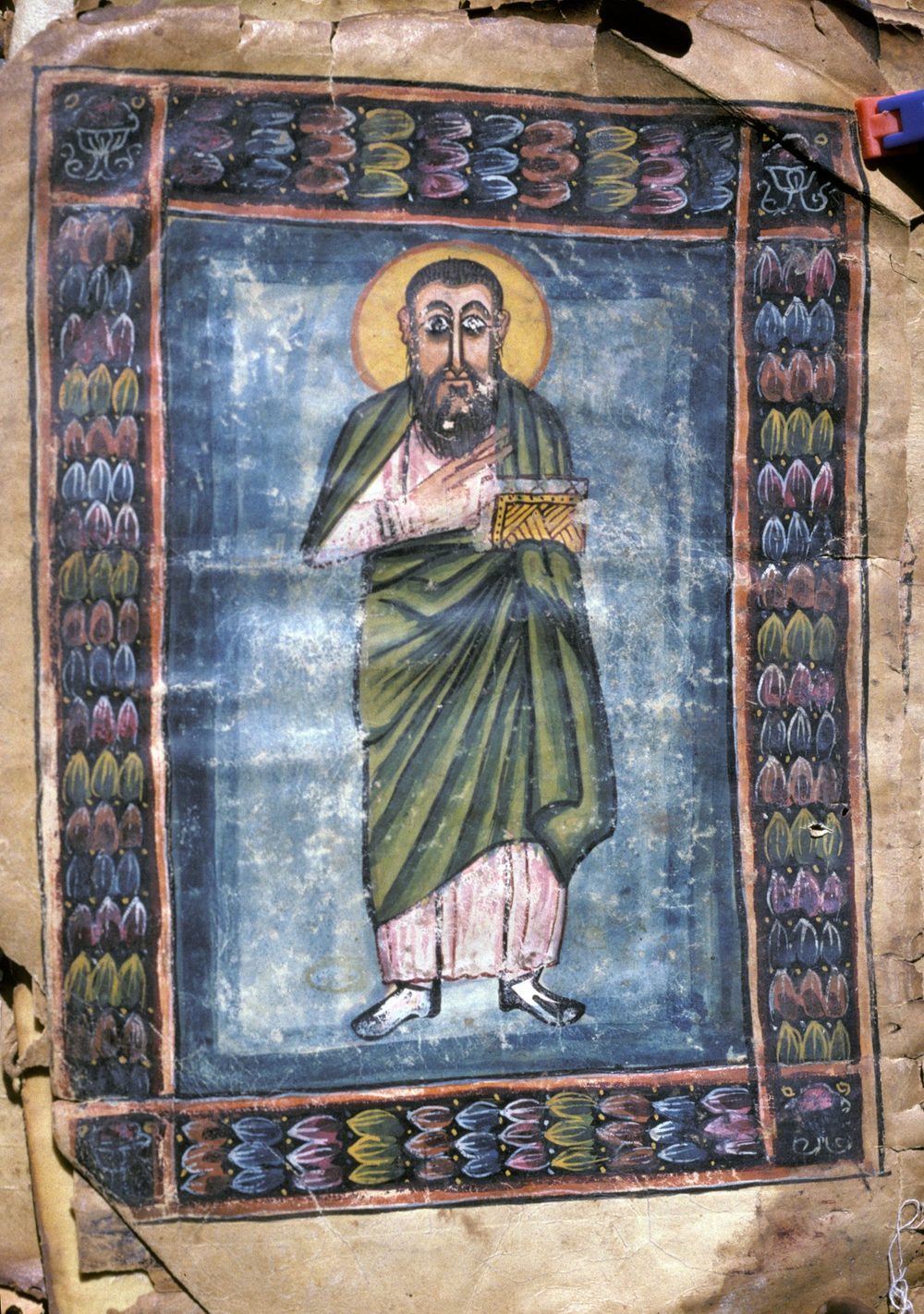 Ícone etíope de Eusébio de Cesareia, de pé, com auréola, segurando um livro, em moldura decorada