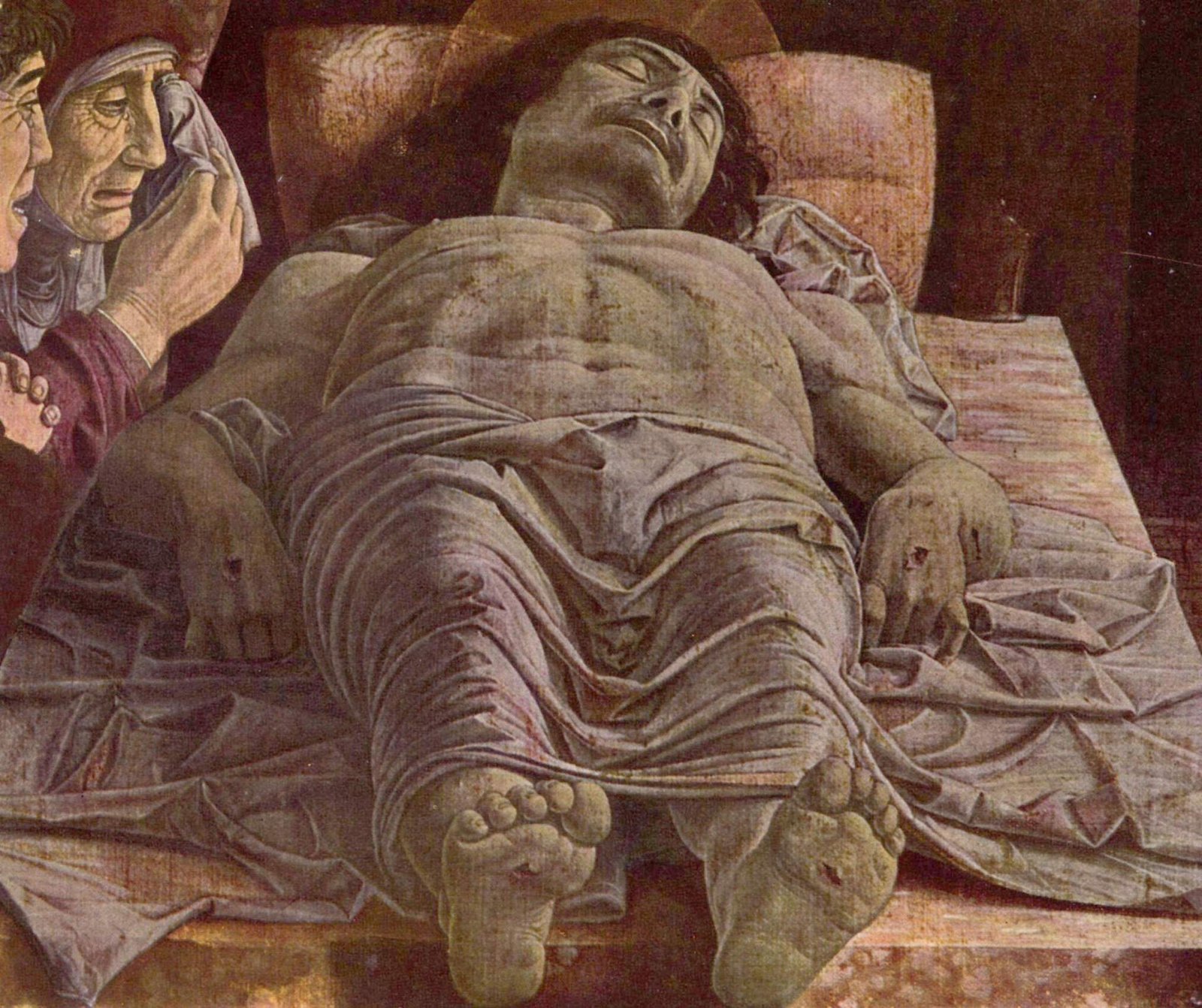 O corpo de Cristo morto estendido sobre a laje, com Maria e João chorando, em pintura de Mantegna