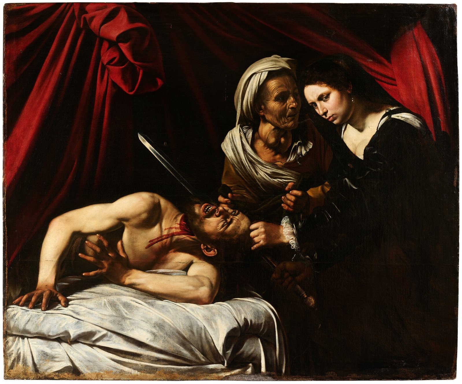 Judite, com a serva ao lado, degola Holofernes na cama, em pintura barroca de forte contraste entre luz e sombra