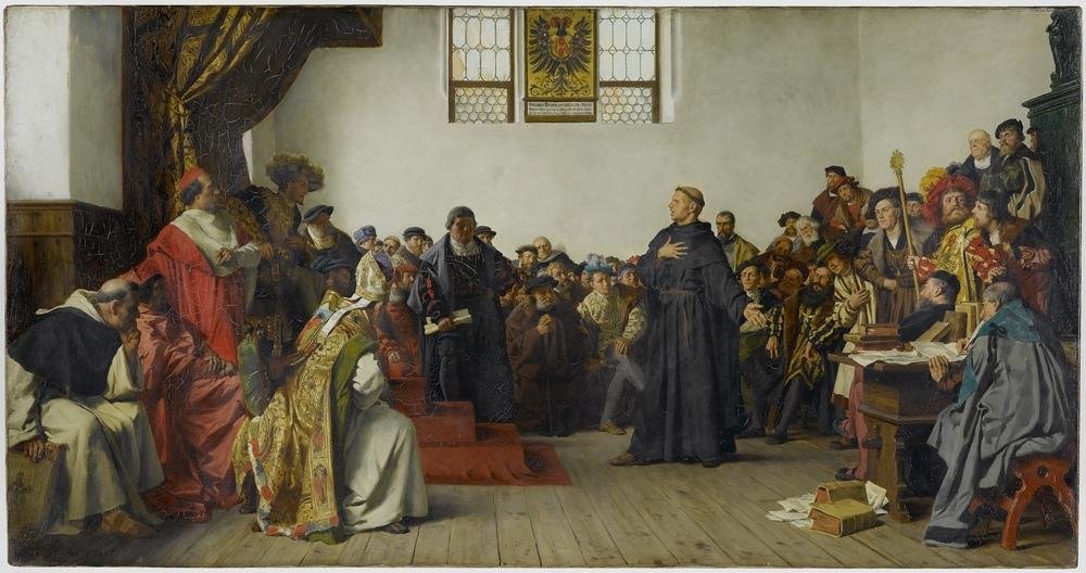 Pintura de Lutero diante do imperador Carlos V e dos príncipes na Dieta de Worms, com a mão no peito